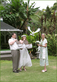 Married couple release doves after ceremony with the minister