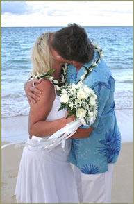 Kissing bride and groom by the beautiful water